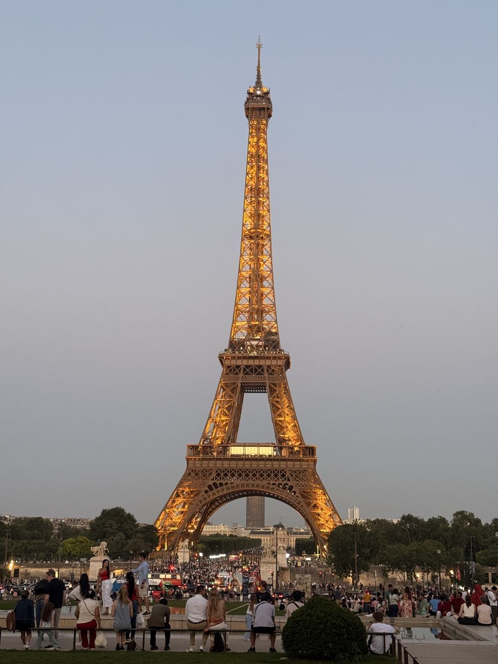 The Eiffel Tower lit gold at dusk, from Trocadéro