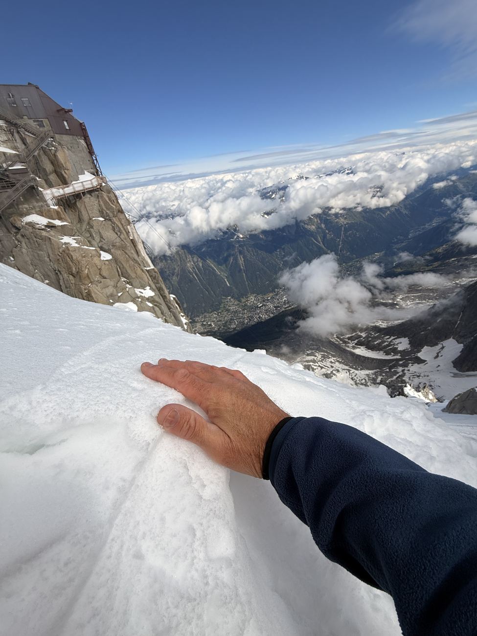 A hand on June snow